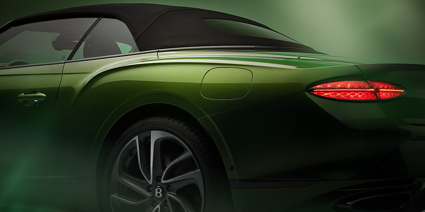 Bentley Tbilisi Bentley New Continental GTC Speed rear haunch and tail lamp in Tourmaline Green paint and dark tint brightware with black hood up and illuminated head lamps