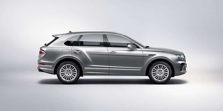 Bentley Tbilisi Bentley Bentayga SUV side profile in Moonbeam silver paint against white background featuring 21 inch 5 spoke wheels